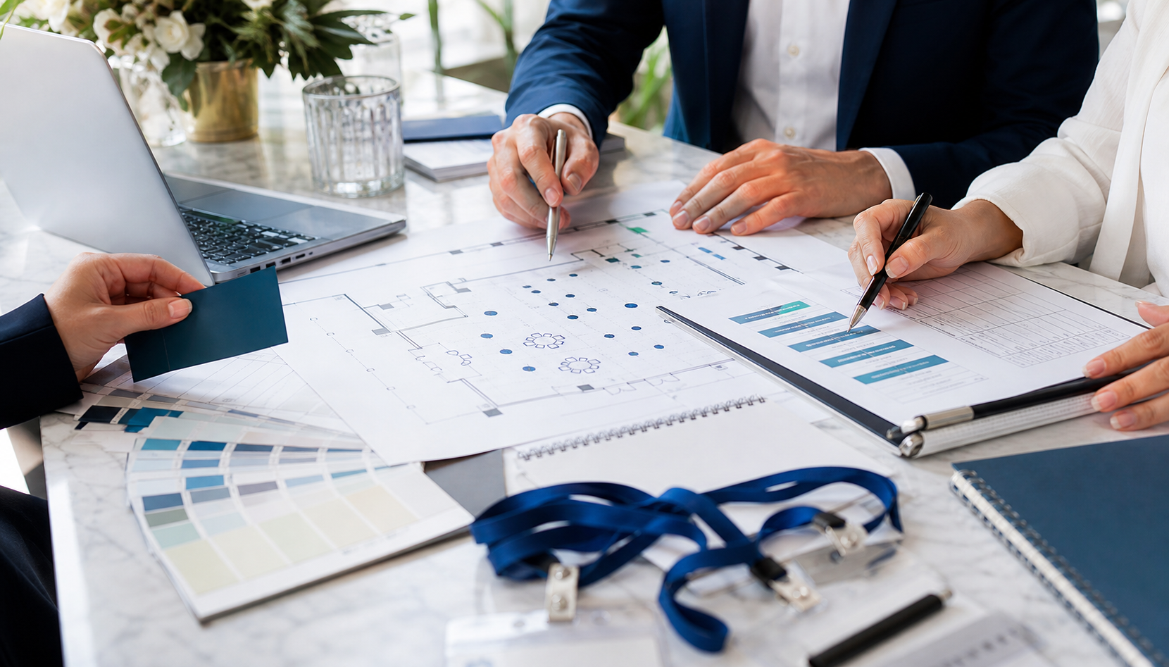 Corporate planners reviewing an event floor plan
